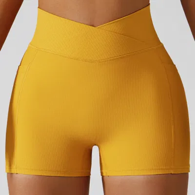 Venda quente de tecido elástico com costelas para meninas de cintura alta Calças quentes para mulheres com levantamento de bunda esportiva Executar shorts de ioga com bolsos